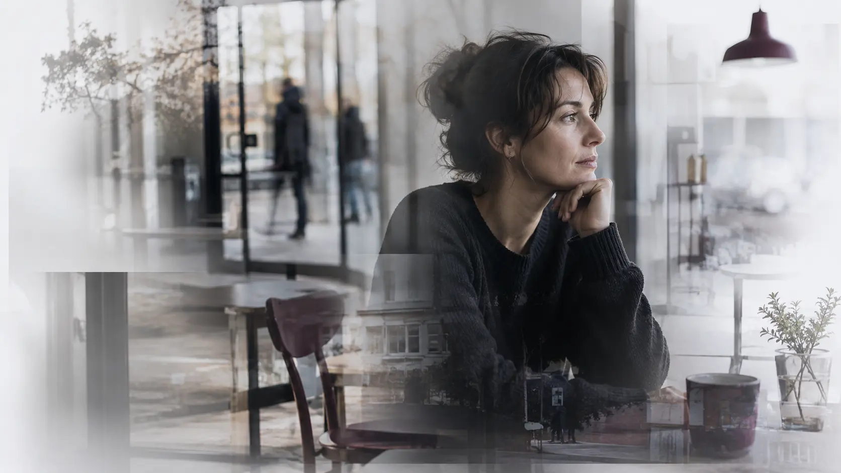 Witness reflecting on a remembered event behind glass